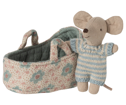 Toy mouse in overalls standing next to a floral-patterned baby carriage on a white background