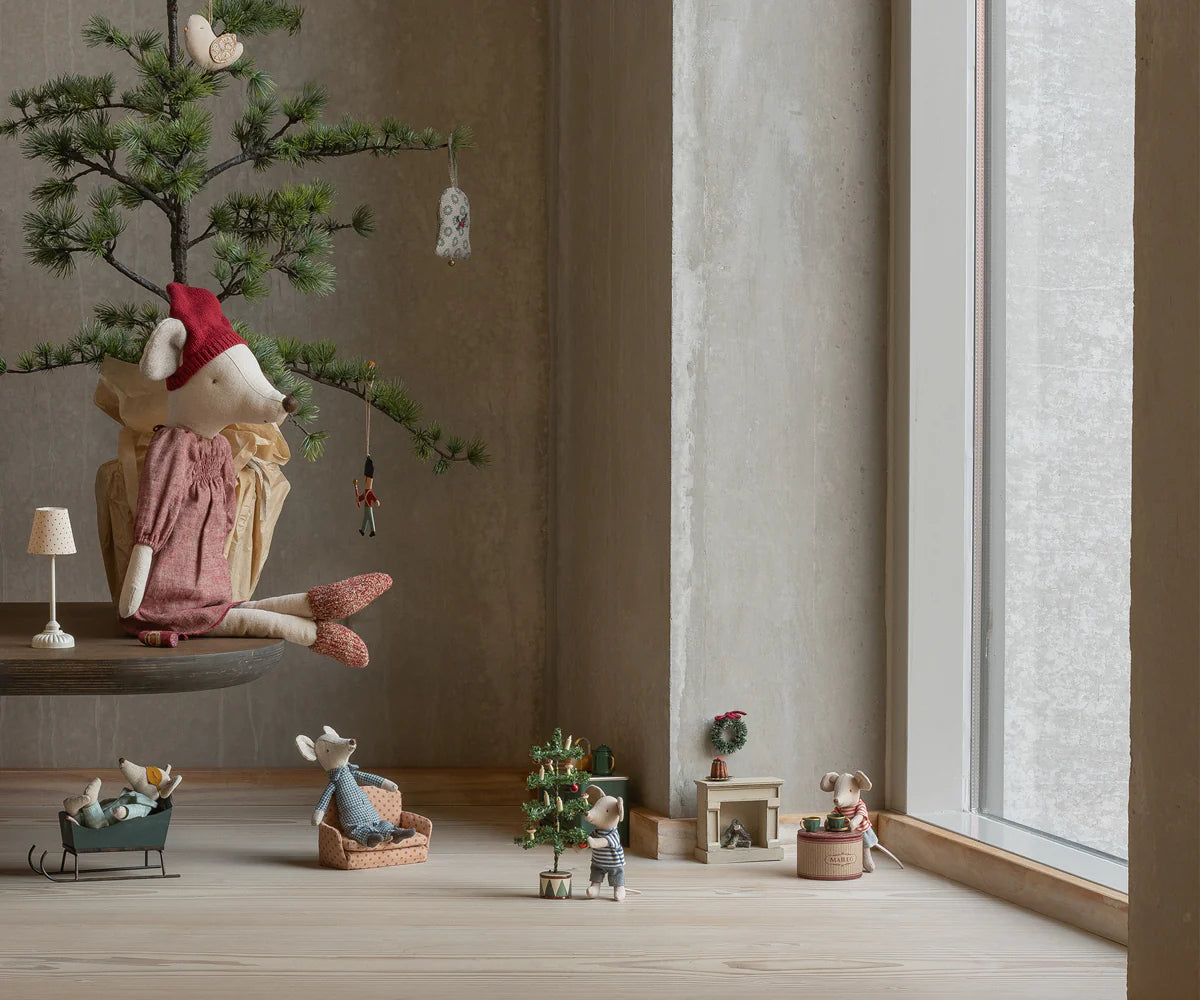 Decorative scene with small figurines and a miniature tree in a room with large windows. | Maileg UK