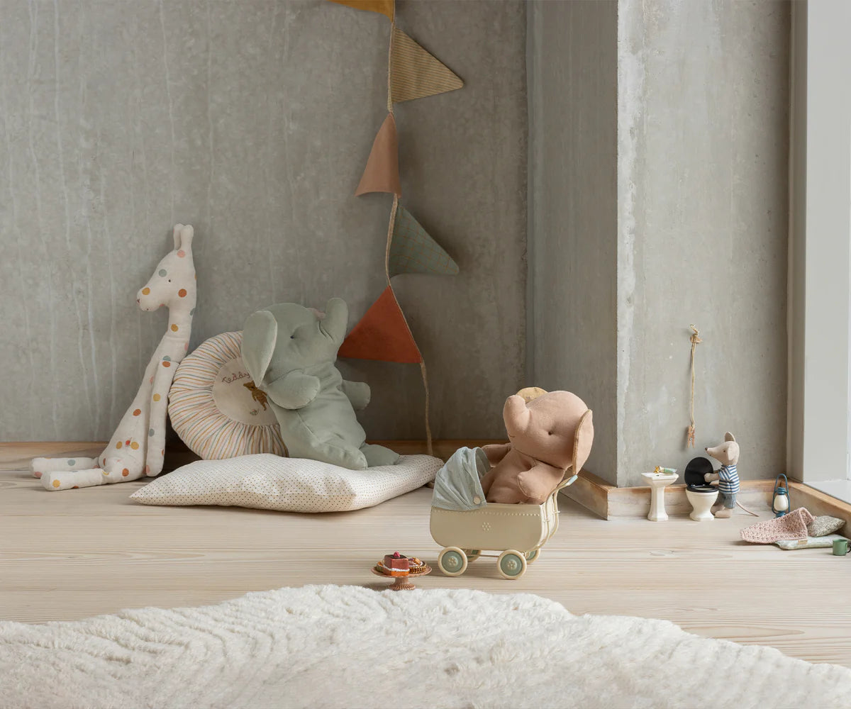 Children's toys and plushies on a wooden floor against a neutral wall. | Maileg uk