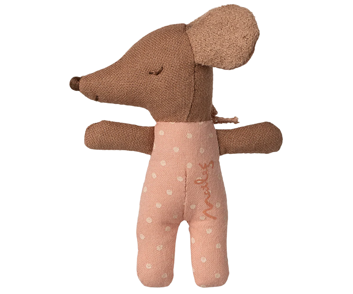 Brown plush toy with a pink outfit on a white background