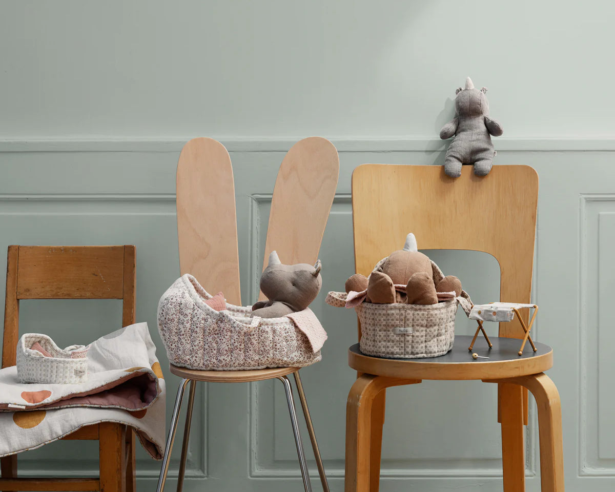 Wooden chairs with toys and baskets against a light gray wall | Maileg UK
