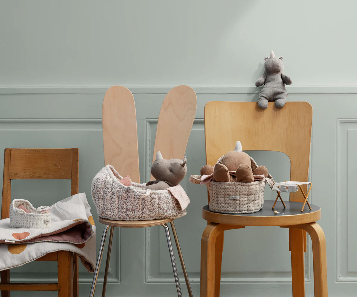 Wooden chairs with toys and baskets against a light gray wall | Maileg UK