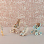 Small toy figures with strollers against a floral-patterned background | Maileg UK