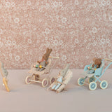 Small toy figures with strollers against a floral-patterned background | Maileg UK