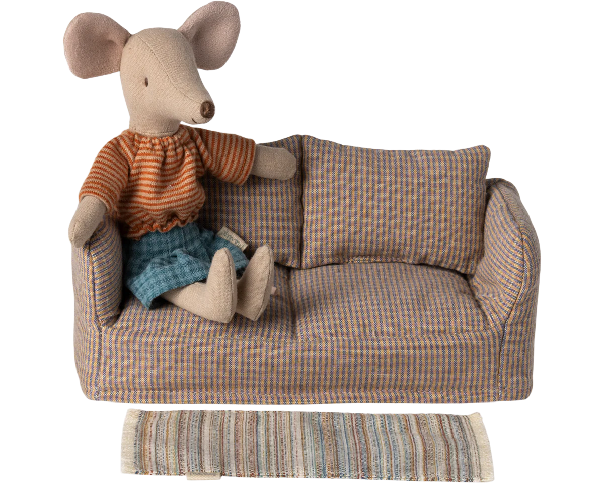 Stuffed mouse toy in a plaid sofa with a striped blanket on a white background | Maileg uk