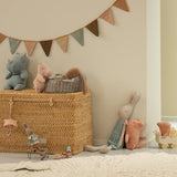 Wicker basket with toys and a decorative banner in a child's room | Maileg UK