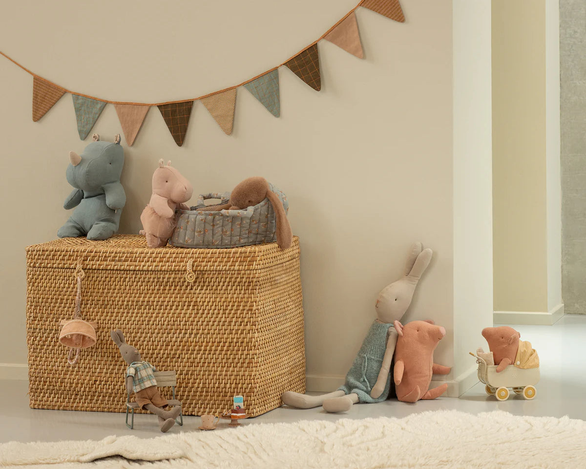 Wicker basket with toys and a decorative banner in a child's room | Maileg UK