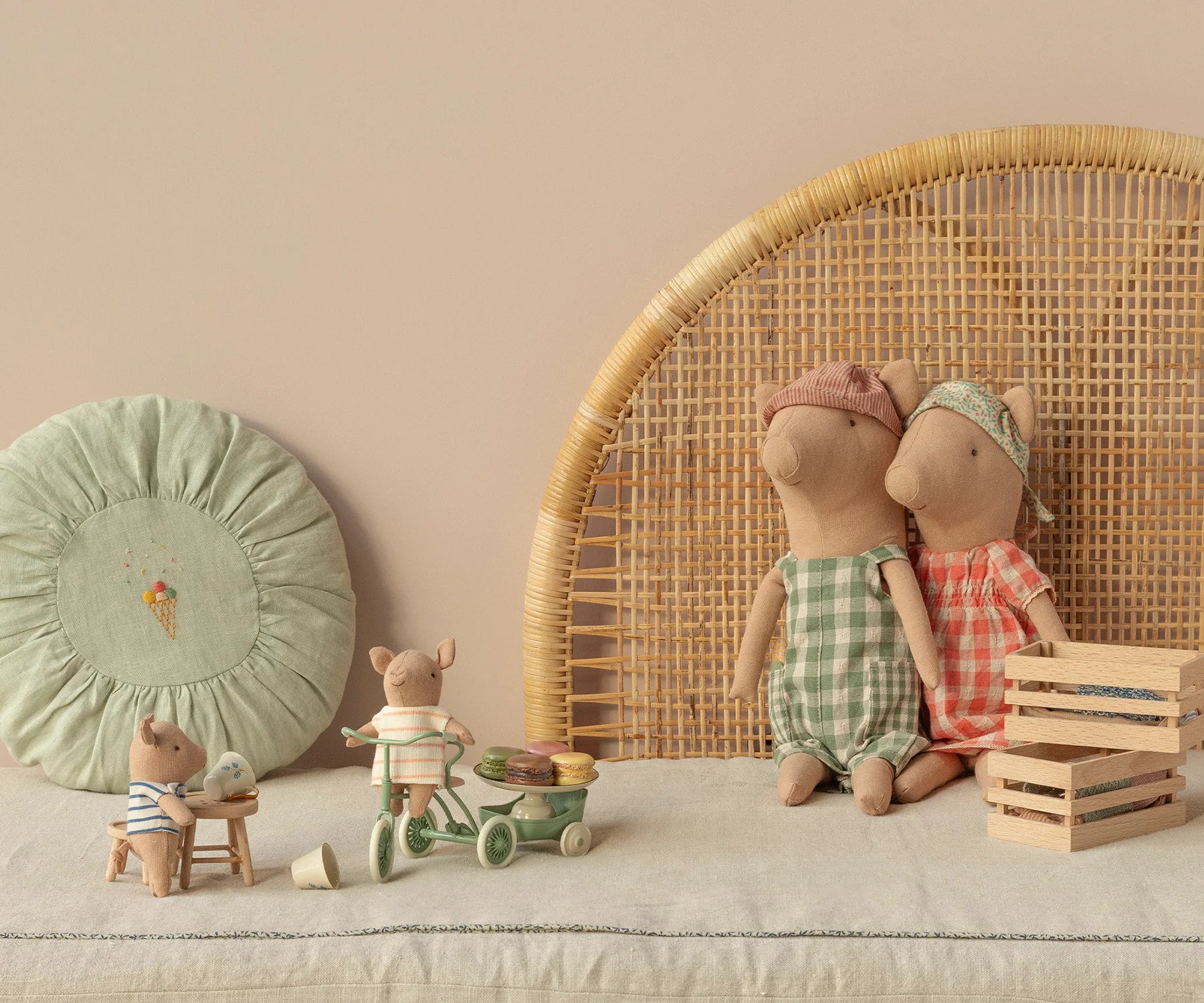 Children's toys and dolls on a neutral background with a wicker chair and decorative items. | Maileg UK