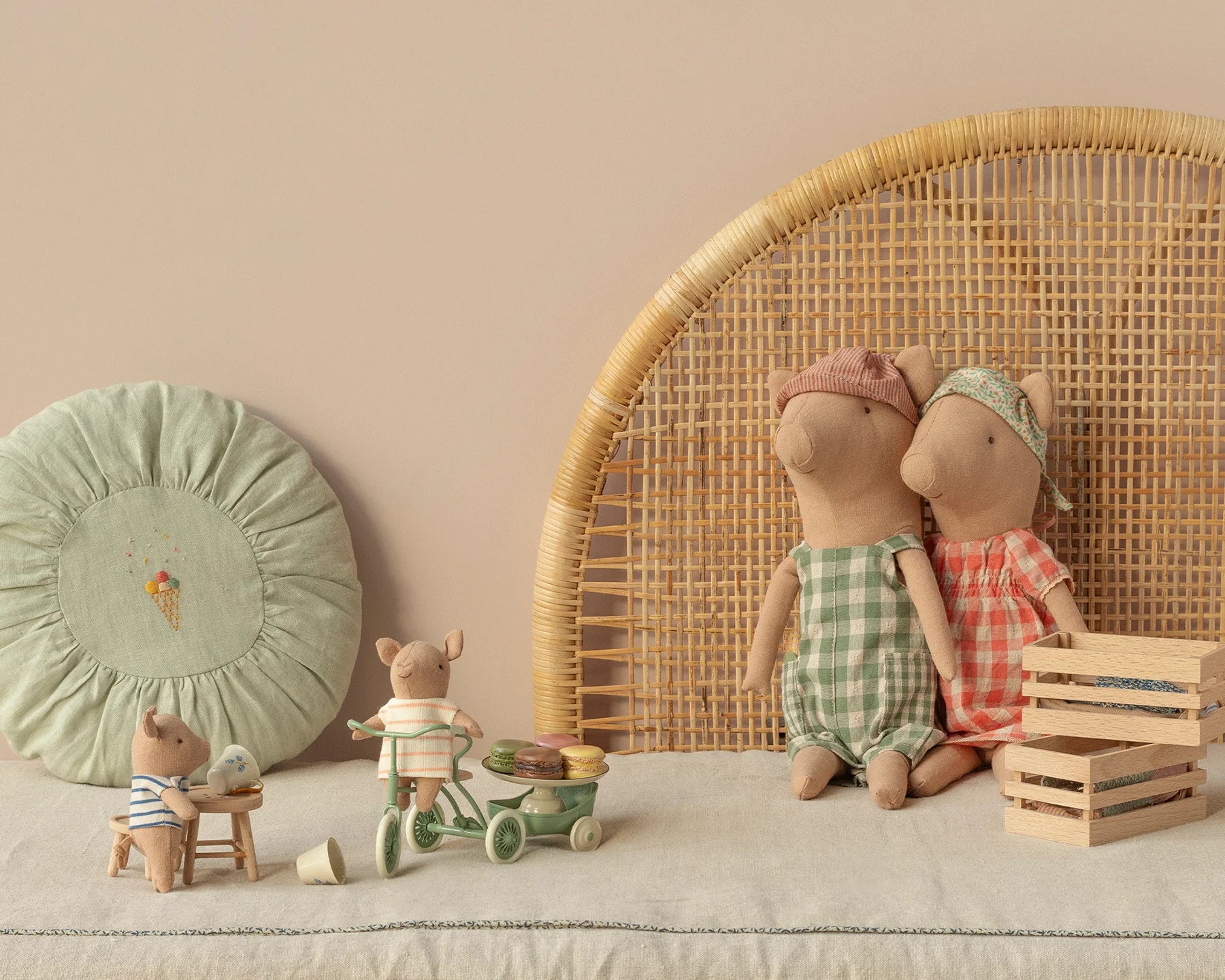 Children's toys and dolls on a neutral background with a wicker chair and decorative items. | Maileg UK