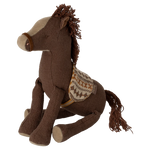 Brown plush horse toy with a saddle on a white background