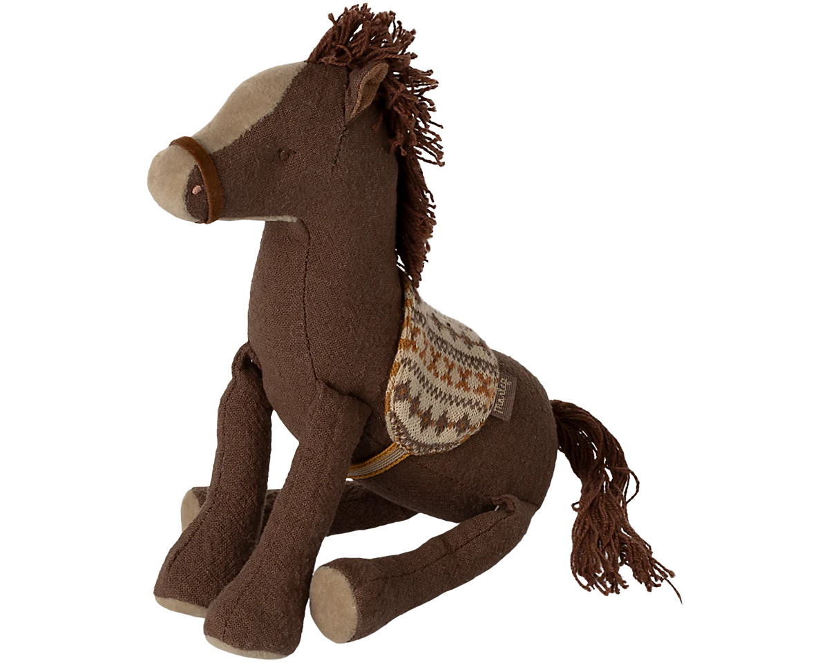 Brown plush horse toy with a saddle on a white background