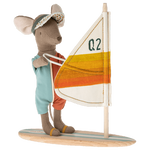 Maileg Surfer Beach mouse on his wakeboard with orange stripes on the sail and a wooden board with blue stripes. His hands are magnetic to hold on to the sail.
