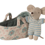 Toy mouse in overalls standing next to a floral-patterned baby carriage on a white background