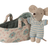 Toy mouse in overalls standing next to a floral-patterned baby carriage on a white background