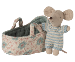 Toy mouse in overalls standing next to a floral-patterned baby carriage on a white background