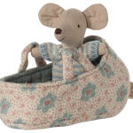 Stuffed mouse toy in a floral-patterned crib on a white background