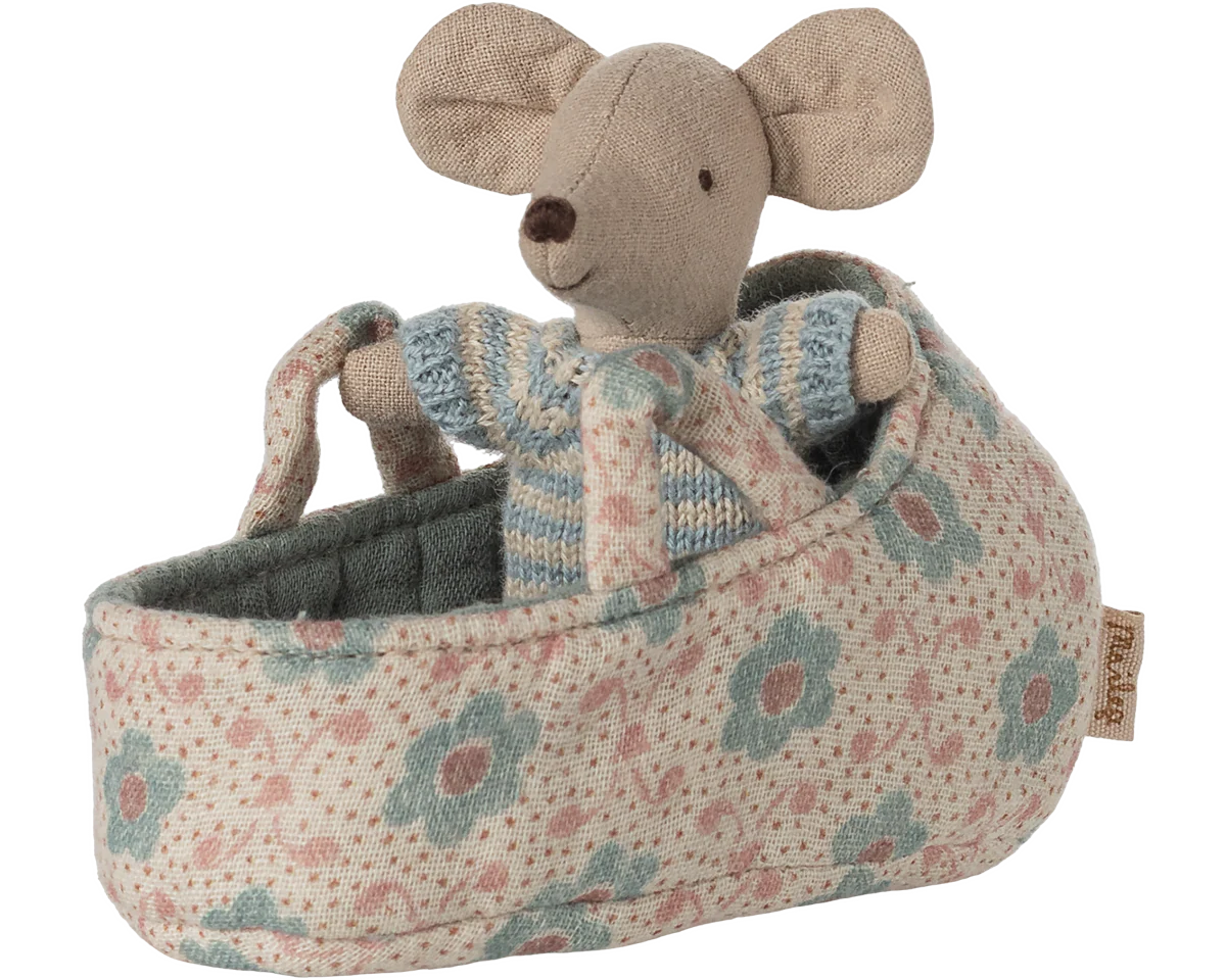 Stuffed mouse toy in a floral-patterned crib on a white background