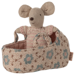 Stuffed mouse toy in a floral-patterned basket on a white background