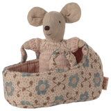Stuffed mouse toy in a floral-patterned basket on a white background
