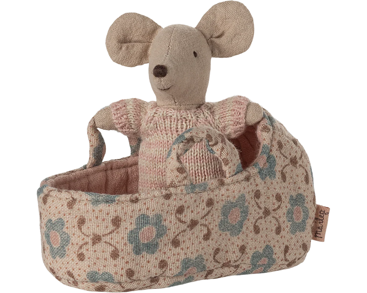 Stuffed mouse toy in a floral-patterned basket on a white background