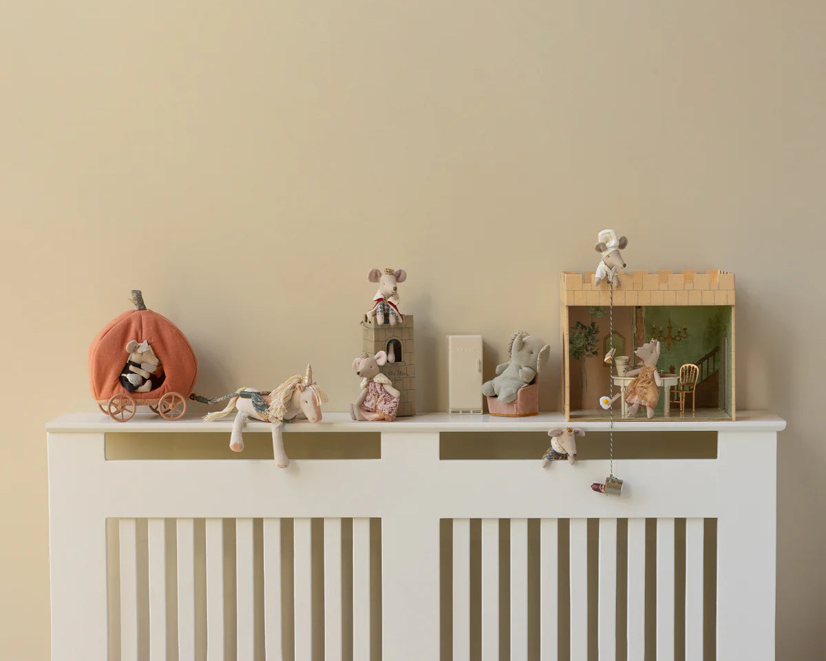 Decorative shelf with small figurines on a white cabinet against a beige wall | Maileg UK