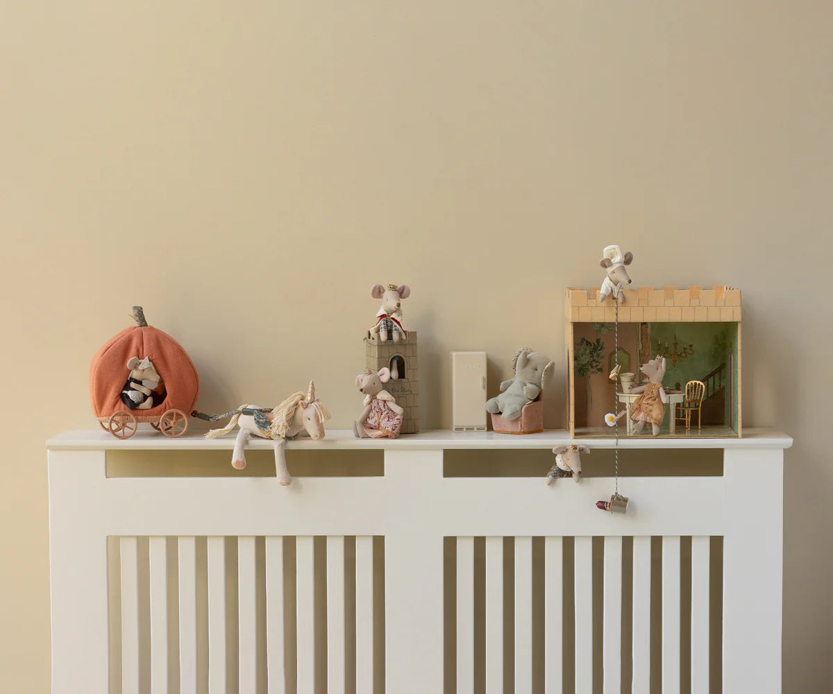 Decorative shelf with small figurines on a white cabinet against a beige wall | Maileg UK