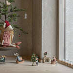 Decorative scene with small figurines and a miniature tree in a room with large windows. | Maileg UK