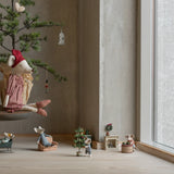 Decorative scene with small figurines and a miniature tree in a room with large windows. | Maileg UK