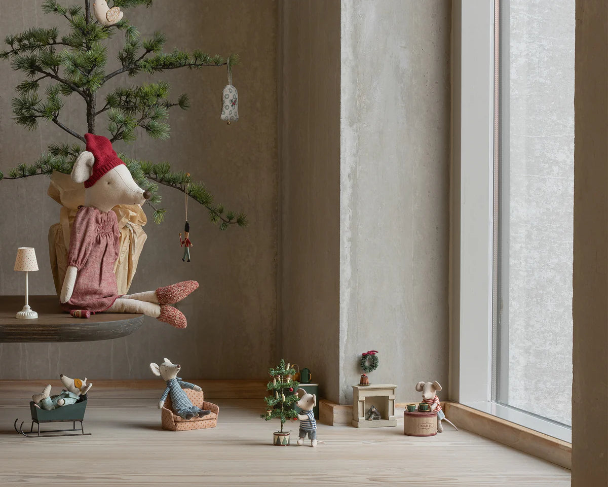 Decorative scene with small figurines and a miniature tree in a room with large windows. | Maileg UK