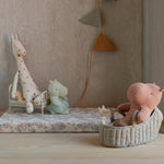 Children's room with stuffed animals on a floral bedspread and wall decorations. | Maileg UK
