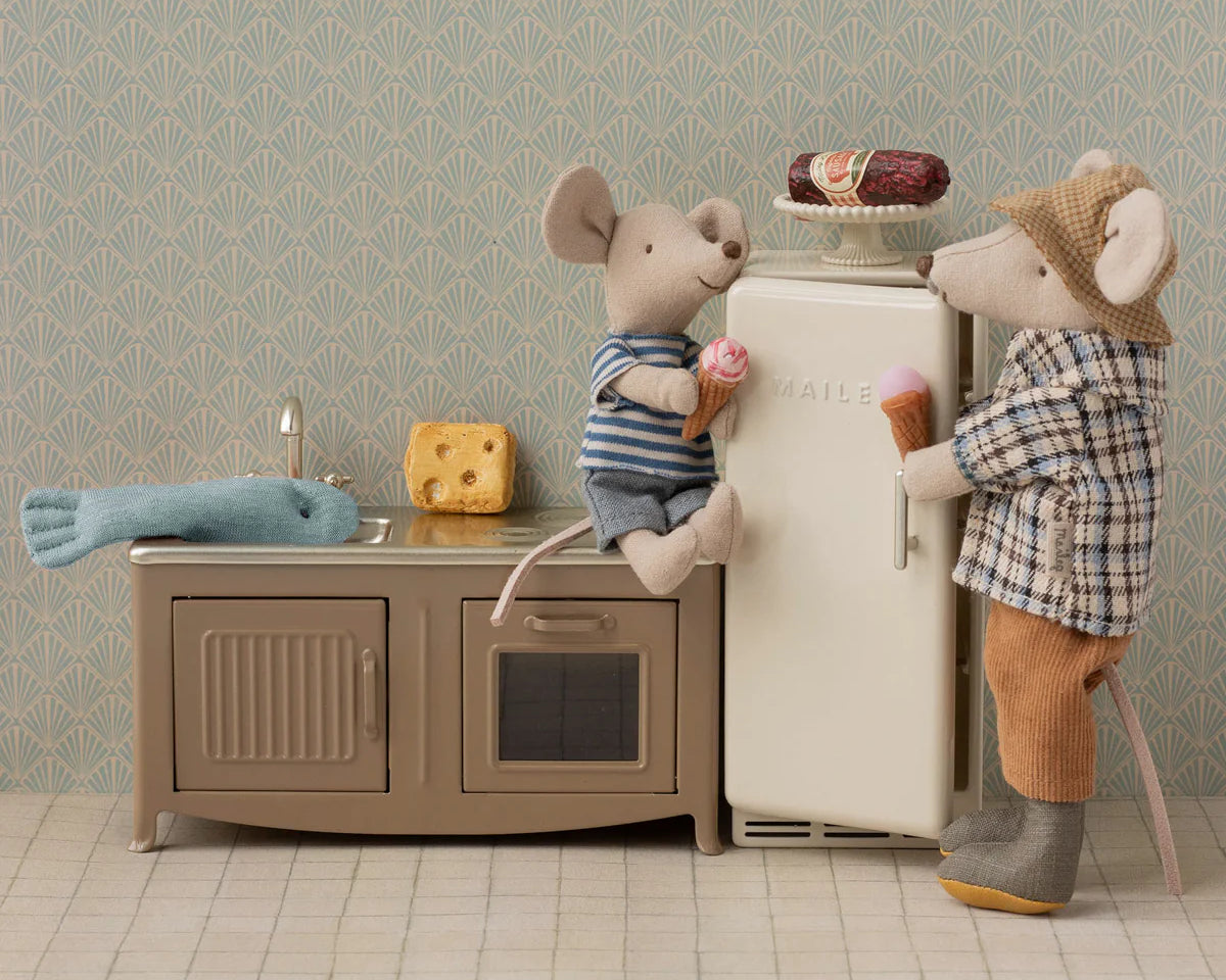 Two toy mice in a kitchen setting with a refrigerator and sink. | Maileg UK