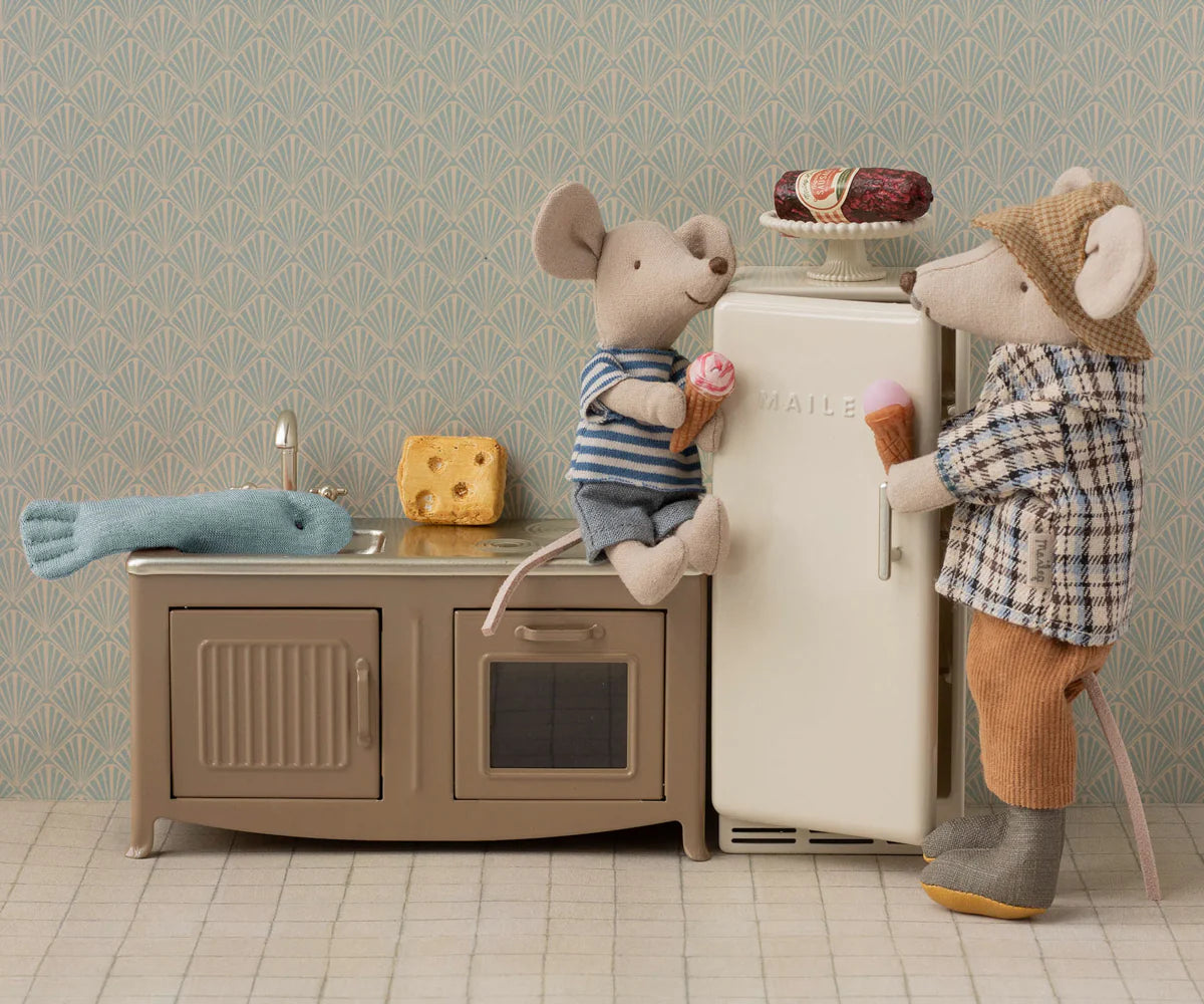 Two toy mice in a kitchen setting with a refrigerator and sink. | Maileg UK