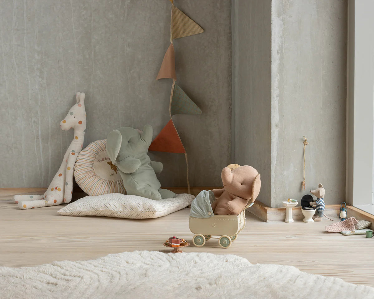 Children's toys and plushies on a wooden floor against a neutral wall. | Maileg uk
