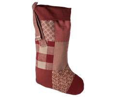 Patchwork Christmas stocking with red, brown, and beige patterns on a white background