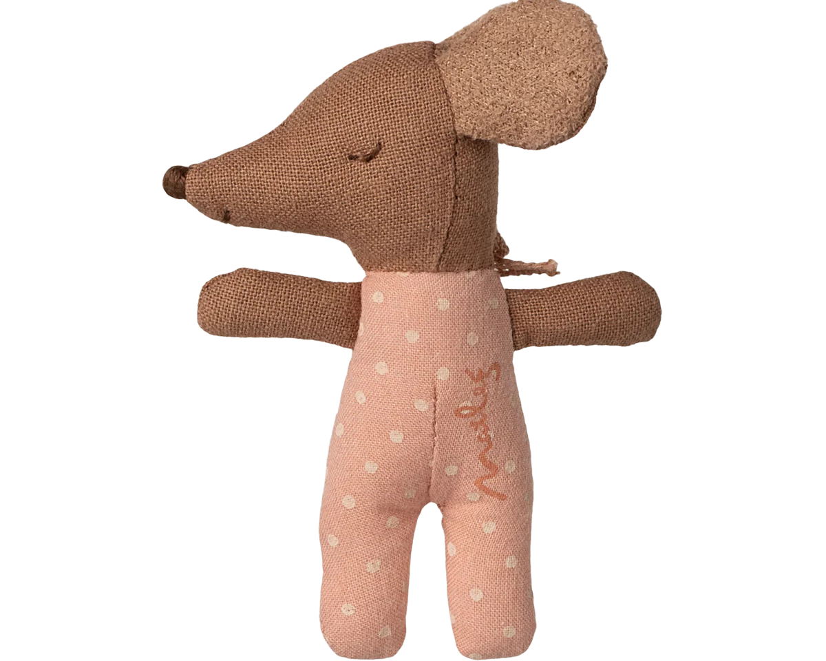 Brown plush toy with a pink outfit on a white background