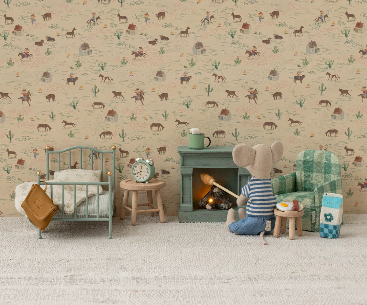 Children's room with toy mouse by a fireplace, teddy bear, and patterned wallpaper. | Maileg UK