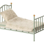 Small green metal bed with beige bedding on a white background | Maileg UK