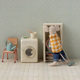 Small mouse character cleaning a miniature room with a washing machine and chair. | Maileg UK