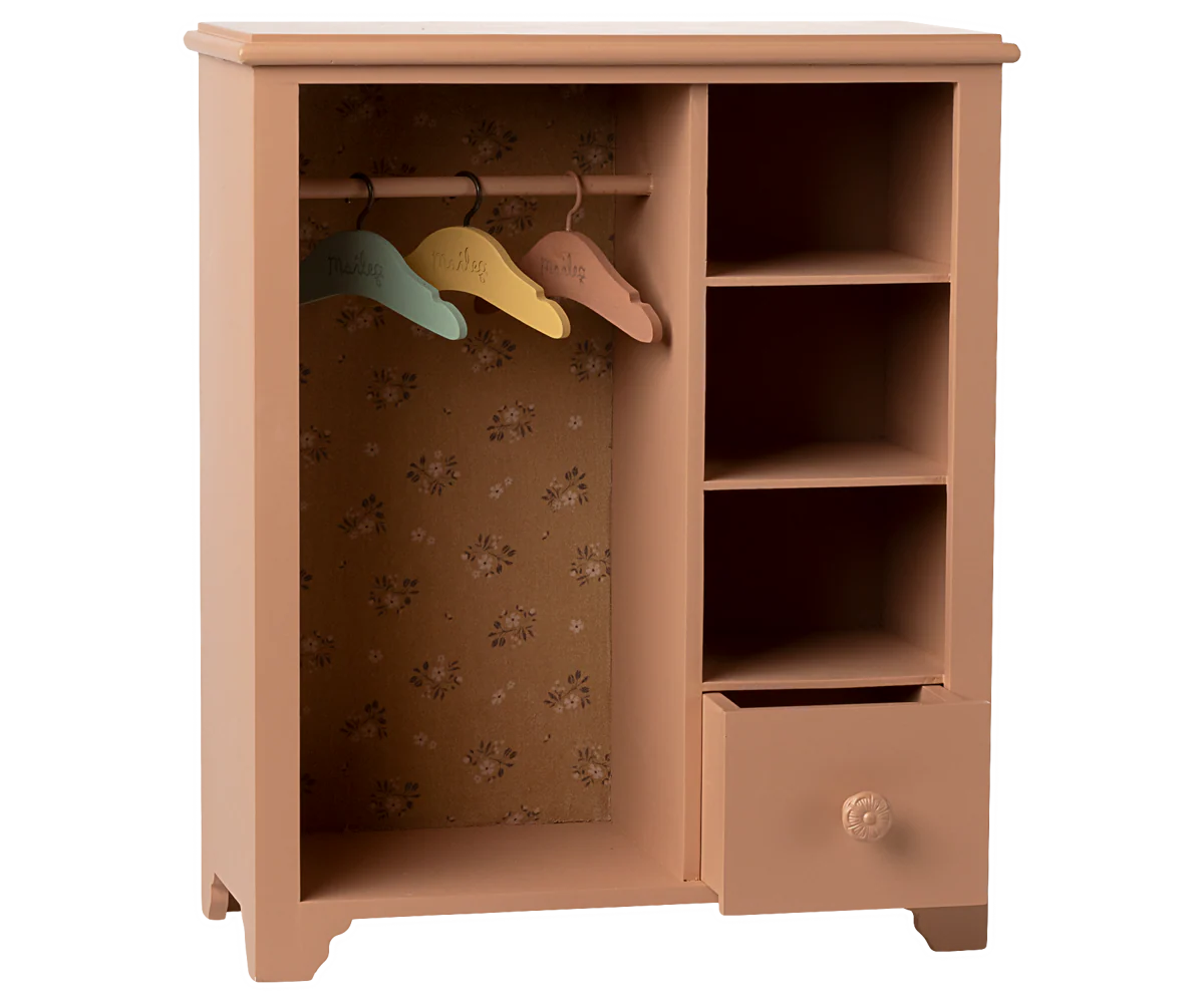 Wooden wardrobe with colorful hangers on a white background