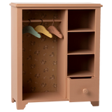 Wooden wardrobe with colorful hangers on a white background