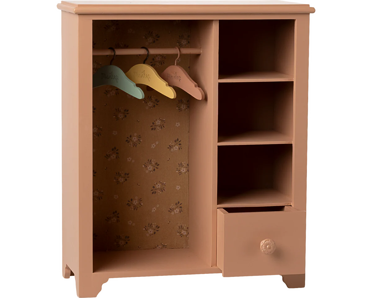 Wooden wardrobe with colorful hangers on a white background