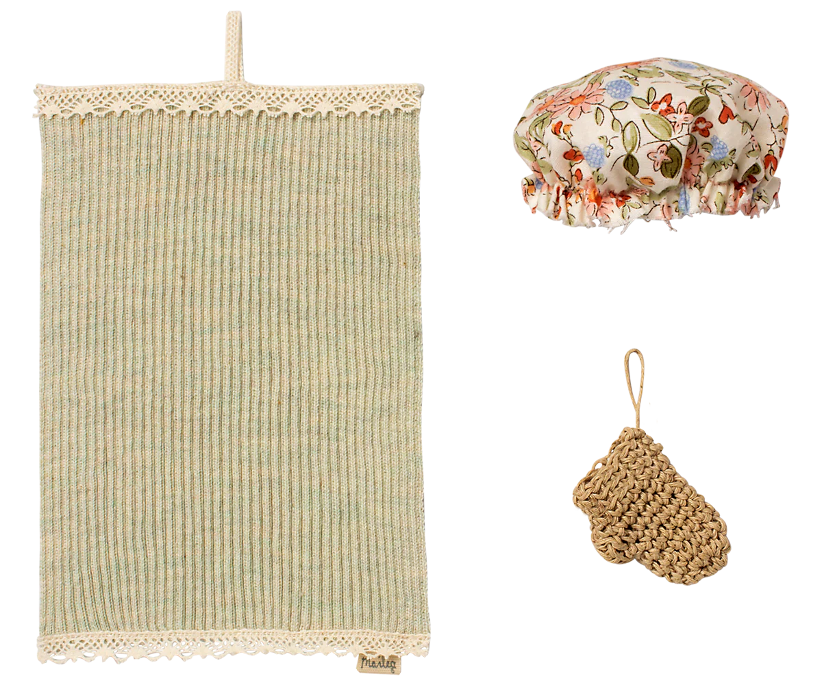 Set of miniature bath items including a textured towel, floral shower cap, and scrubber on a white background | Maileg UK