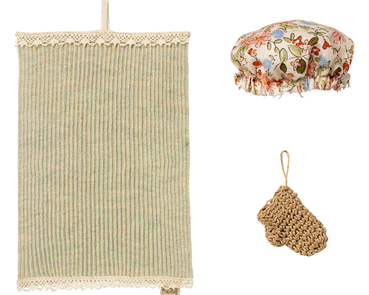 Set of miniature bath items including a textured towel, floral shower cap, and scrubber on a white background | Maileg UK