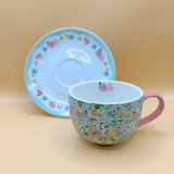 Cath kidston cup and saucer with a better view of the plate with a blue rim and floral pattern - quaint british tea party ready