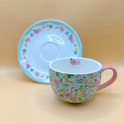 Cath kidston cup and saucer with a better view of the plate with a blue rim and floral pattern - quaint british tea party ready