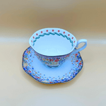 showing the detailing on the inside rim of the tea cup and the cath kidton floral pattern on the saucer from above, a colourful vintage design