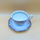 showing the detailing on the inside rim of the tea cup and the cath kidton floral pattern on the saucer from above, a colourful vintage design