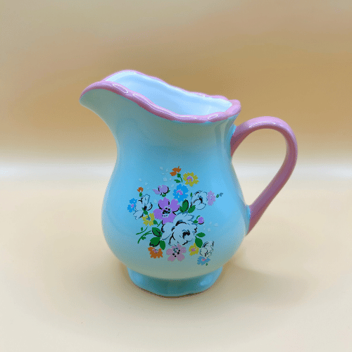 Blue / teal milk jug with a pink handle and vintage kitsch cath kidston floral pattern. Perfect for tea party or pouring cream on your desserts.