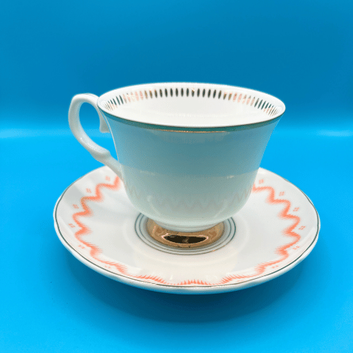 A view of the simple back of the bone china cup and saucer with gold details inside the rim of the cup. Perfect for a bridgerton style get together