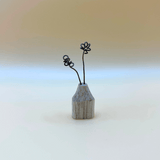 Small wooden vase with wire flowers on a gradient background